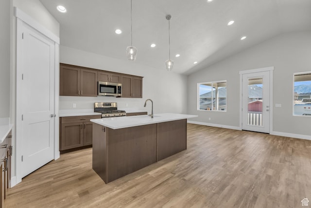 2711 S Allison Way Unit 101, Syracuse, UT 84075 - kitchen with appliances with stainless steel finishes, a sink, light wood finished floors, lofted ceiling, and light countertops