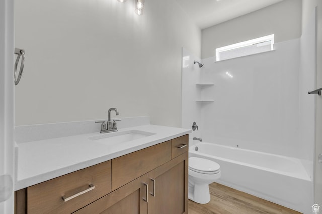 2711 S Allison Way Unit 101, Syracuse, UT 84075 - bathroom with toilet, vanity, wood finished floors, and bathing tub / shower combination