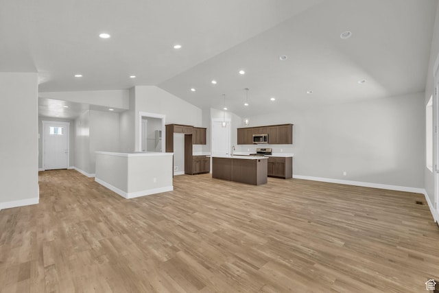 2711 S Allison Way Unit 101, Syracuse, UT 84075 - unfurnished living room with vaulted ceiling, light wood-type flooring, baseboards, a sink, and recessed lighting