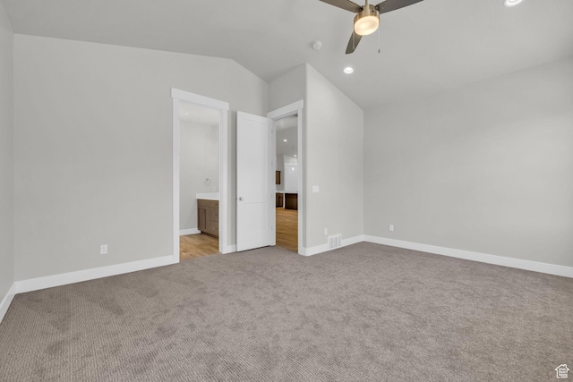 2711 S Allison Way Unit 101, Syracuse, UT 84075 - unfurnished bedroom featuring carpet flooring, recessed lighting, baseboards, vaulted ceiling, and ensuite bath
