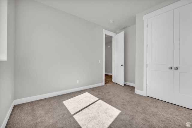 2711 S Allison Way Unit 101, Syracuse, UT 84075 - unfurnished bedroom with carpet, baseboards, and a closet