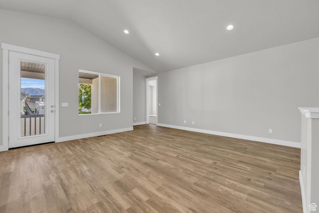 2711 S Allison Way Unit 101, Syracuse, UT 84075 - unfurnished living room featuring lofted ceiling, light wood-type flooring, recessed lighting, and baseboards