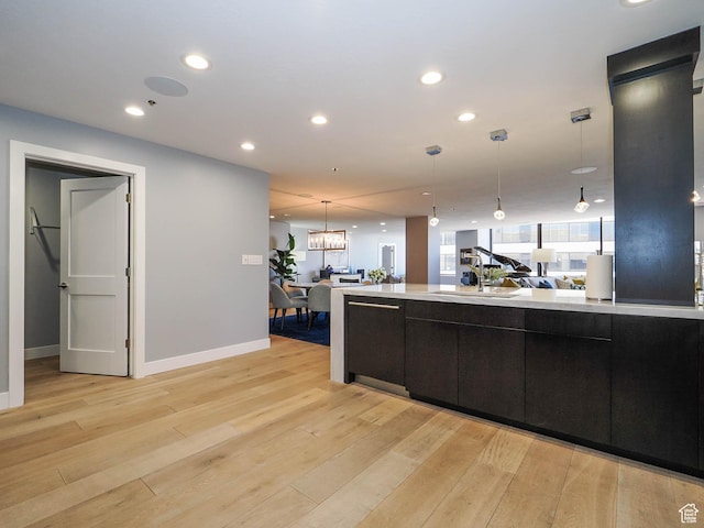 48 W 300 S Unit 2502-N, Salt Lake City, UT 84101 - kitchen featuring light wood-type flooring, light countertops, decorative light fixtures, and recessed lighting