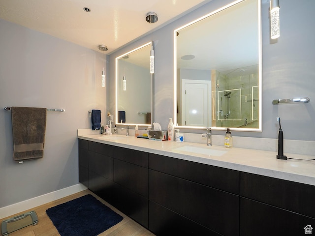 48 W 300 S Unit 2502-N, Salt Lake City, UT 84101 - bathroom featuring a stall shower, double vanity, and baseboards