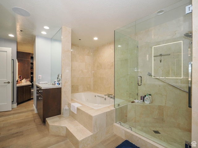 48 W 300 S Unit 2502-N, Salt Lake City, UT 84101 - full bath with vanity, a whirlpool tub, a stall shower, wood finished floors, and recessed lighting