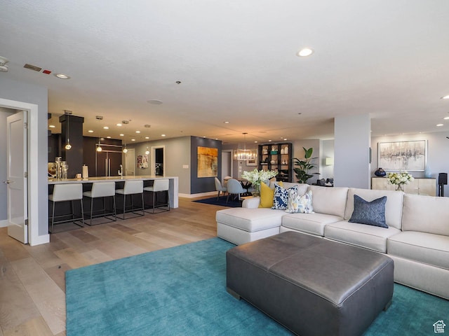 48 W 300 S Unit 2502-N, Salt Lake City, UT 84101 - living room featuring light wood-style flooring, recessed lighting, baseboards, and a chandelier