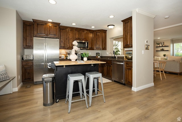1908 W 1020 N, Provo, UT 84604 - kitchen featuring stainless steel appliances, recessed lighting, a kitchen bar, a kitchen island, and light wood-style flooring