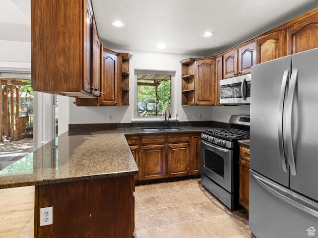 1206 W 3300 N, Pleasant Grove, UT 84062 - kitchen with appliances with stainless steel finishes, open shelves, a sink, dark stone countertops, and recessed lighting