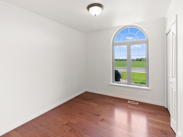 1206 W 3300 N, Pleasant Grove, UT 84062 - unfurnished bedroom featuring wood finished floors, multiple windows, baseboards, and ornamental molding