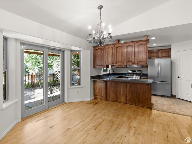 1206 W 3300 N, Pleasant Grove, UT 84062 - kitchen with freestanding refrigerator, gas range oven, a chandelier, a peninsula, and light wood finished floors