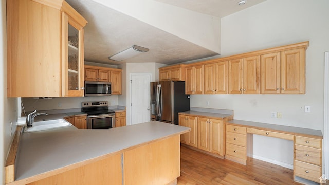 10205 N 3900 W, Cedar Hills, UT 84062 - kitchen with stainless steel appliances, a sink, light brown cabinetry, and light wood-style flooring