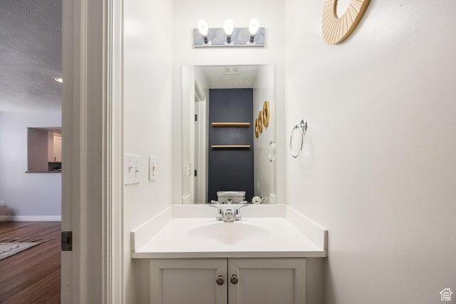 3421 E Dundee Dr, Eagle Mountain, UT 84005 - half bathroom featuring vanity, wood finished floors, and baseboards