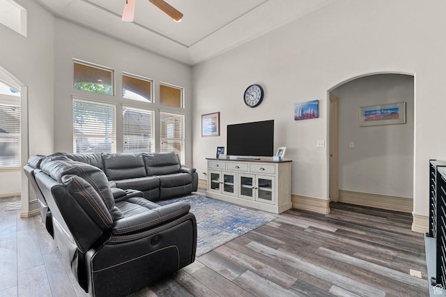 14163 S Friendship Dr W, Herriman, UT 84065 - living area featuring ceiling fan, wood finished floors, arched walkways, a high ceiling, and baseboards