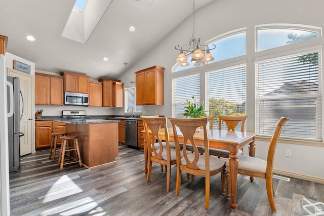14163 S Friendship Dr W, Herriman, UT 84065 - kitchen with stainless steel appliances, dark wood finished floors, a kitchen island, a chandelier, and brown cabinets