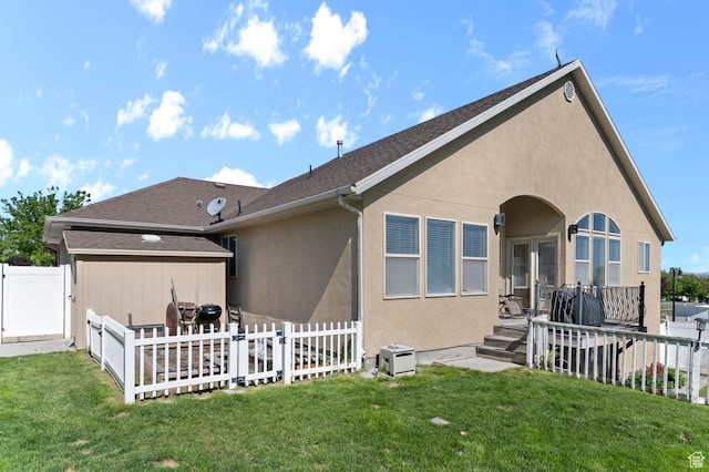 14163 S Friendship Dr W, Herriman, UT 84065 - rear view of house with stucco siding and a gate