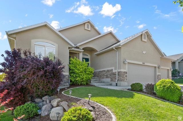14163 S Friendship Dr W, Herriman, UT 84065 - view of front facade with stone siding, an attached garage, stucco siding, and a front yard