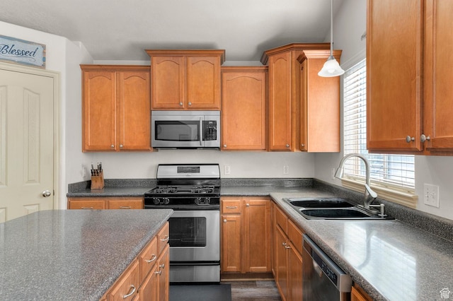 14163 S Friendship Dr W, Herriman, UT 84065 - kitchen featuring appliances with stainless steel finishes, a sink, dark countertops, and brown cabinetry