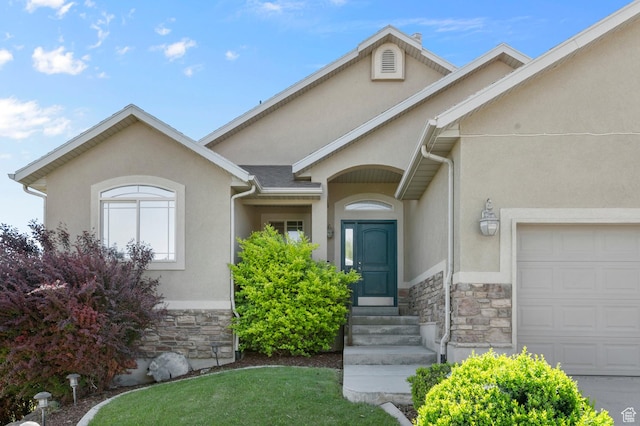 14163 S Friendship Dr W, Herriman, UT 84065 - view of front facade featuring stone siding, stucco siding, a garage, and a front yard
