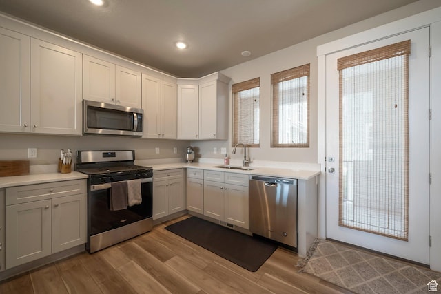 898 S 2560 E, Spanish Fork, UT 84660 - kitchen with appliances with stainless steel finishes, a sink, light wood finished floors, light countertops, and recessed lighting