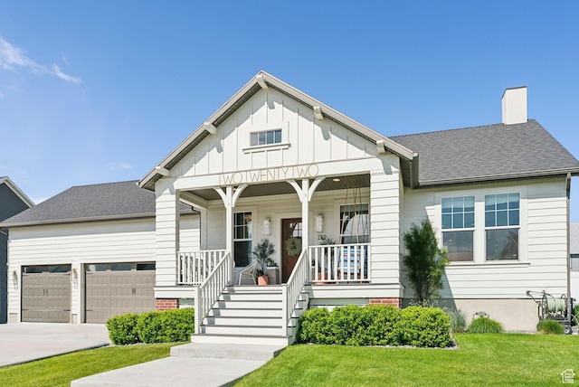 222 S Summer Breeze Ln, Layton, UT 84041 - bungalow-style house featuring an attached garage, a porch, a front yard, driveway, and a chimney