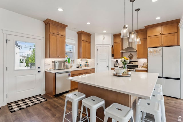 222 S Summer Breeze Ln, Layton, UT 84041 - kitchen with appliances with stainless steel finishes, dark wood-style floors, backsplash, a kitchen breakfast bar, and recessed lighting