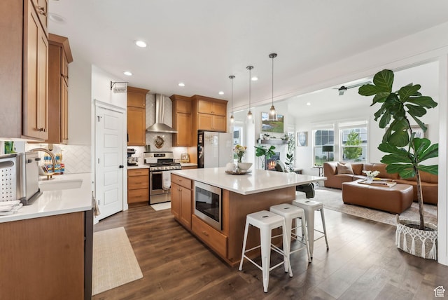 222 S Summer Breeze Ln, Layton, UT 84041 - kitchen with stainless steel appliances, wall chimney exhaust hood, a sink, dark wood finished floors, and recessed lighting