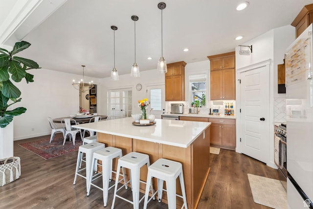 222 S Summer Breeze Ln, Layton, UT 84041 - kitchen featuring a breakfast bar, a kitchen island, dark wood-style flooring, light countertops, and recessed lighting