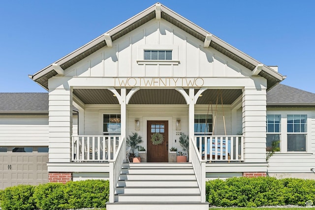 222 S Summer Breeze Ln, Layton, UT 84041 - doorway to property with covered porch, board and batten siding, a shingled roof, and an attached garage