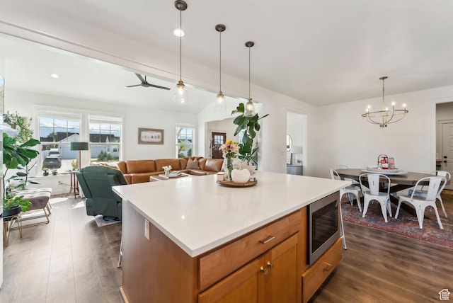 222 S Summer Breeze Ln, Layton, UT 84041 - kitchen with stainless steel microwave, a chandelier, dark wood-style flooring, and open floor plan