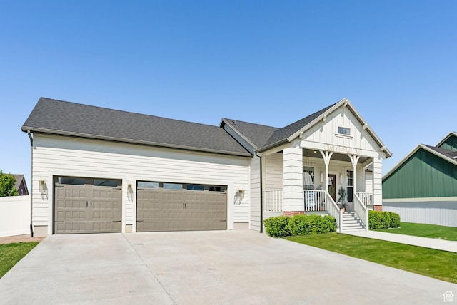 222 S Summer Breeze Ln, Layton, UT 84041 - view of front of property featuring a porch, driveway, board and batten siding, and an attached garage
