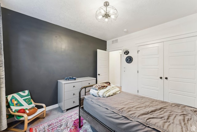 222 S Summer Breeze Ln, Layton, UT 84041 - bedroom with a closet, a textured ceiling, light carpet, and baseboards