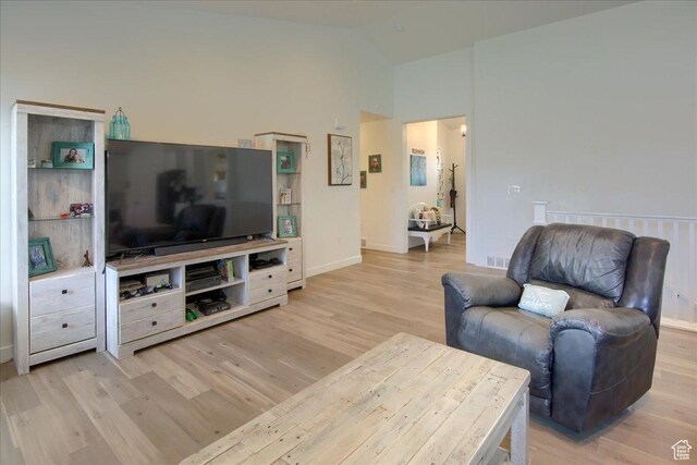 958 W Regatta Ln, Stansbury Park, UT 84074 - living area with light wood-style floors, high vaulted ceiling, and baseboards