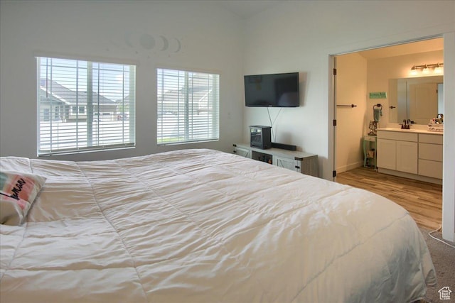958 W Regatta Ln, Stansbury Park, UT 84074 - bedroom with wood finished floors, a sink, baseboards, and connected bathroom