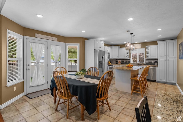 3285 S 575 W, Syracuse, UT 84075 - dining space with plenty of natural light, baseboards, a chandelier, recessed lighting, and a textured ceiling