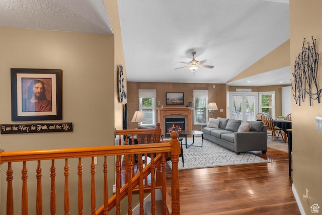 3285 S 575 W, Syracuse, UT 84075 - living room with a ceiling fan, a glass covered fireplace, wood finished floors, plenty of natural light, and a textured ceiling