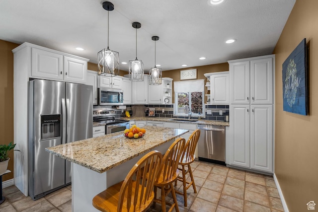 3285 S 575 W, Syracuse, UT 84075 - kitchen with appliances with stainless steel finishes, open shelves, decorative backsplash, white cabinetry, and recessed lighting