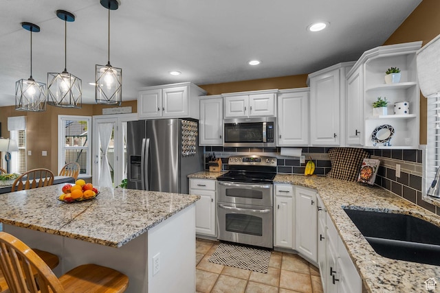 3285 S 575 W, Syracuse, UT 84075 - kitchen featuring stainless steel appliances, a kitchen bar, decorative backsplash, white cabinets, and recessed lighting