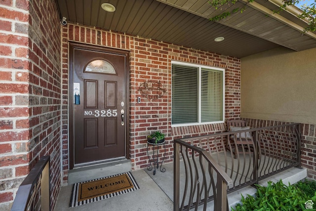 3285 S 575 W, Syracuse, UT 84075 - property entrance featuring brick siding, a porch, and a security system