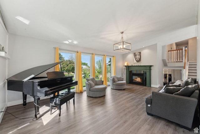3407 S 325 W, Bountiful, UT 84010 - living area featuring wood finished floors, a glass covered fireplace, baseboards, and stairway