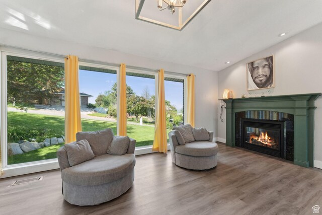 3407 S 325 W, Bountiful, UT 84010 - sitting room with lofted ceiling, wood finished floors, a glass covered fireplace, a chandelier, and recessed lighting