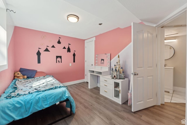 3407 S 325 W, Bountiful, UT 84010 - bedroom with light wood-style flooring, baseboards, and connected bathroom