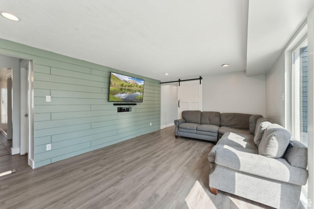 3407 S 325 W, Bountiful, UT 84010 - living area with a barn door, wood finished floors, wood walls, recessed lighting, and baseboards