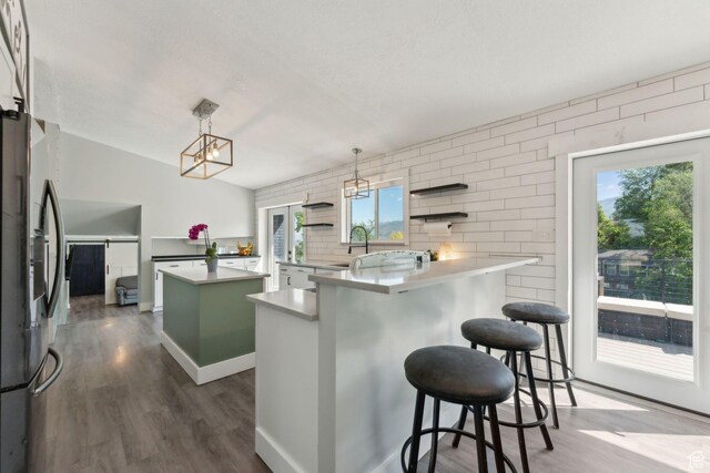 3407 S 325 W, Bountiful, UT 84010 - kitchen featuring stainless steel fridge with ice dispenser, dark wood-style floors, a kitchen island, a kitchen bar, and open shelves