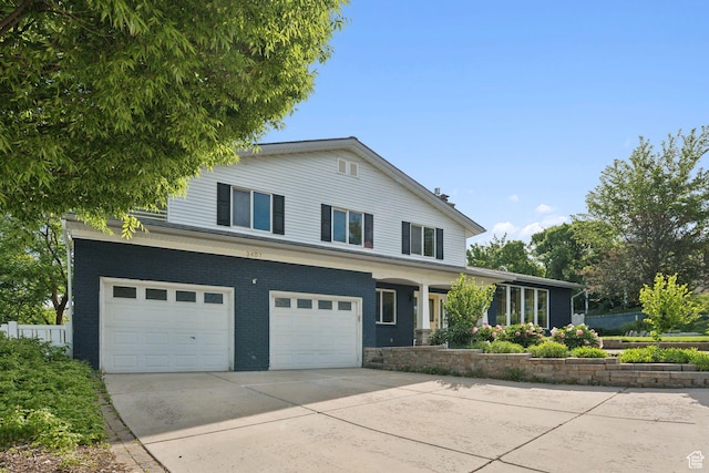 3407 S 325 W, Bountiful, UT 84010 - view of front of home featuring an attached garage, driveway, and brick siding