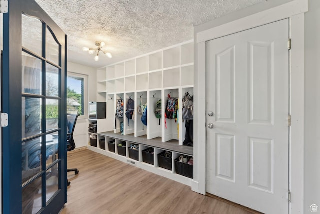 3407 S 325 W, Bountiful, UT 84010 - mudroom with wood finished floors, a textured ceiling, and a chandelier