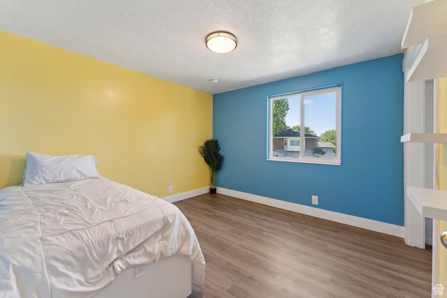 3407 S 325 W, Bountiful, UT 84010 - bedroom featuring wood finished floors, a textured ceiling, and baseboards