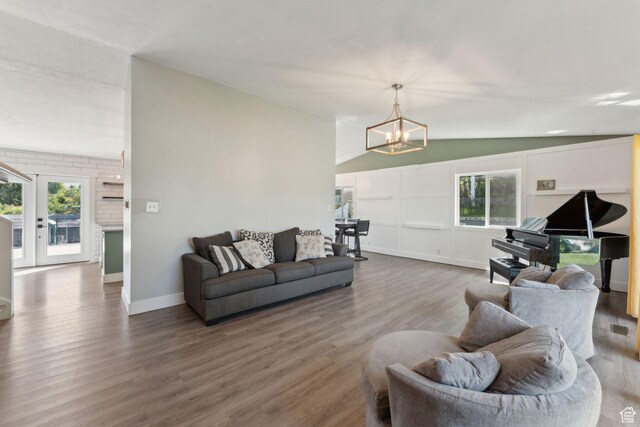 3407 S 325 W, Bountiful, UT 84010 - living area featuring vaulted ceiling, a chandelier, wood finished floors, and baseboards