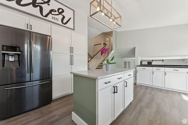 3407 S 325 W, Bountiful, UT 84010 - kitchen with stainless steel refrigerator with ice dispenser, white cabinetry, wood finished floors, backsplash, and pendant lighting