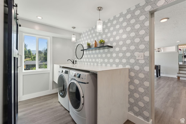 3407 S 325 W, Bountiful, UT 84010 - laundry area featuring independent washer and dryer, baseboards, light wood-style floors, recessed lighting, and an accent wall