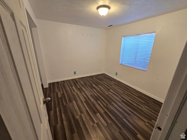 4043 S Lake Vista Dr, Saratoga Springs, UT 84045 - unfurnished bedroom featuring dark wood-type flooring, baseboards, and a textured ceiling
